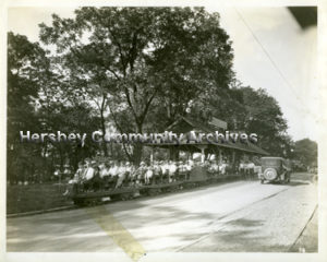 The miniature train carried passengers over Spring Creek to the ball fields located on the far side of the park. ca.1916. Note the carrousel building in background.