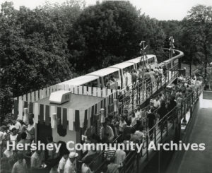 People wait to board the Monorail at the Arena station, August 1969