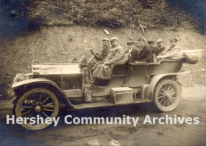 Milton Hershey and colleagues. Left to Right: Front Seat: Chauffeur, Milton Hershey; Second Seat: George Shearer (brother-in-law of Murrie), William Murrie; Third Seat: Ezra Hershey, C.V. Glynn, George Eppley, 1905