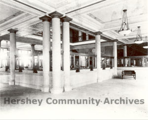 Large windows, massive interior pillars, bronze grill work, mahogany desks and trim, and marble flooring decorated the bank space, ca. 1914-1920