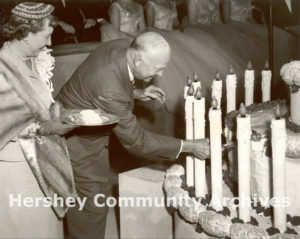 Mamie Eisenhower looks on as President Eisenhower cuts his birthday cake at the Hershey Sports Arena, October 13, 1953