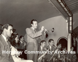 Vocalists Buddy DeVito and Kitty Kallen wait while band leader Harry James performs his trumpet solo at Hershey Park Ballroom, July 25, 1945