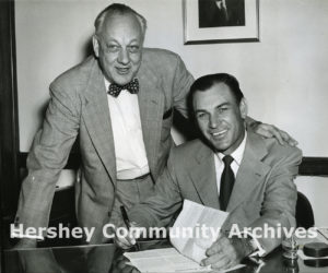John Sollenberger looks on as Ben Hogan signs his contract to serve as golf pro at the Hershey Country Club. ca. 1941