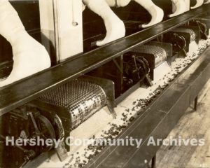 KISSES chocolates coming off of the cooling line after being deposited, ca. 1935