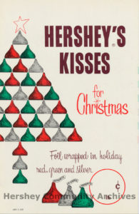 Advertisement for KISSES chocolates wrapped in red, green, and silver foil for the holidays, 1963